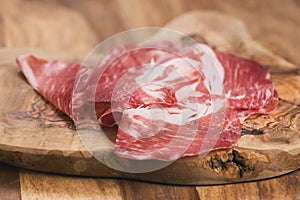 Cured italian coppa on olive wood board