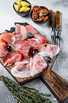 Cured meat platter of traditional Spanish tapas. White background. Top view