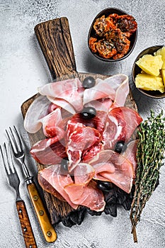 Cured meat platter of traditional Spanish tapas. White background. Top view