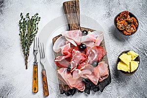 Cured meat platter of traditional Spanish tapas. White background. Top view