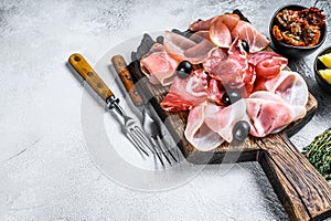 Cured meat platter of traditional Spanish tapas. White background. Top view. Copy space