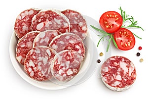 Cured salami sausage in ceramic bowl isolated on white background. Italian cuisine with full depth of field. Top view photo