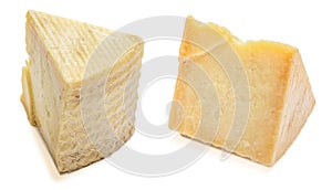 Cured sheep cheese manchego type. Two wedges and portions. Isolated on white background