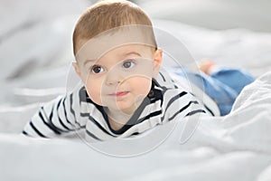 Curious baby boy crawling on the bed