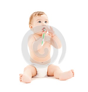 Curious baby brushing teeth