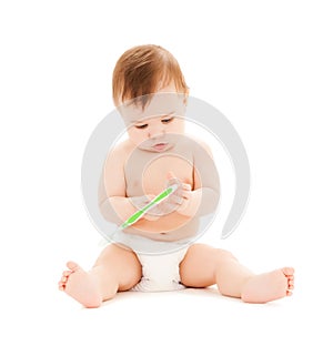 Curious baby brushing teeth
