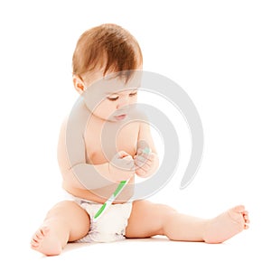 Curious baby brushing teeth