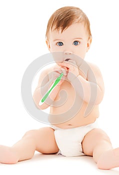 Curious baby brushing teeth