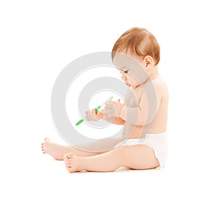 Curious baby brushing teeth