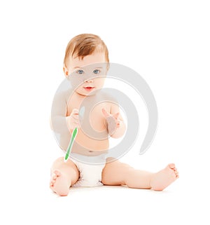 Curious baby brushing teeth