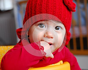 Curious baby girl with red cap