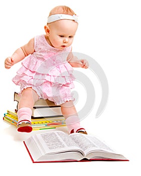 Curious baby reading a book