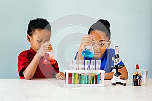 Curious black children experimenting in school chemistry laboratory photo