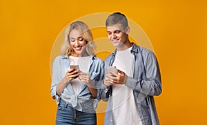 Curious boyfriend peeking into girlfriend`s smartphone, trying to read messages