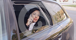 Curious business woman on phone looking from car