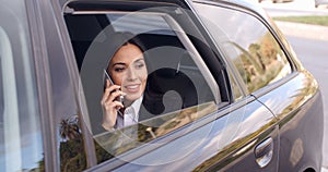 Curious business woman on phone looking from car