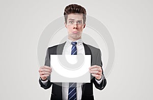 Curious businessman with blank placard