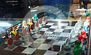 Two men admiring a Marvel characters` chess board