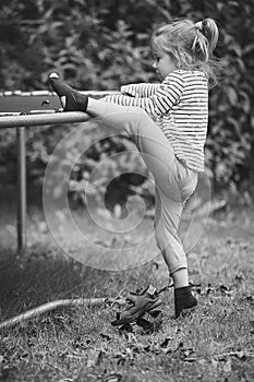 Curious child climbs on a trampoline in the evening garden in Denmark