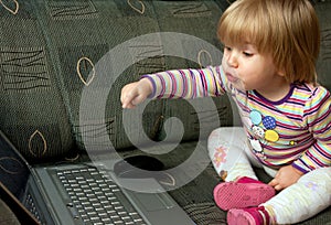 Curious child with computer