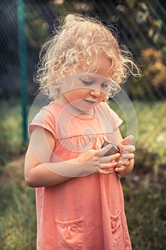 Curious child toddler playing with big snail concept childhood curiosity lifestyle