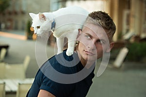 Curious explorer. Happy man on walk with cat pet. Muscular man hold cute pedigree cat. Happy cat owner with muscular