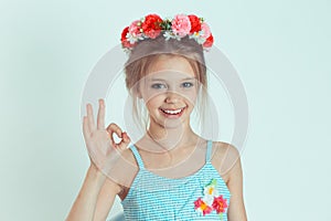 Curious girl looking through fingers like binoculars searching something