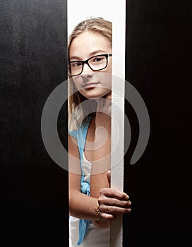 Curious Girl Peeking from Behind Doors