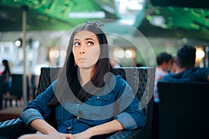 Curious Girl Sitting in a Restaurant Spying on Conversation