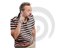 Curious man making listening gesture using finger with copyspace