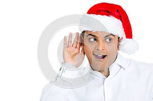 Curious man in red santa hat eavesdropping