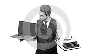 curious man showing pc and typewriter isolated on white background, copy space, technology