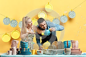 Curious man and woman looking for sports, dust in the kitchenwear