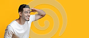 Curious middle-eastern guy smiling and looking at copy space