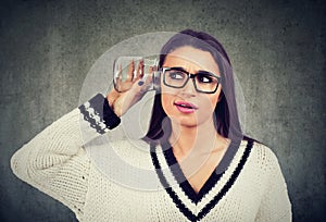 Curious nosy woman with glass jar listening to a private conversation