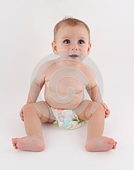 Curious silly funny baby sitting up