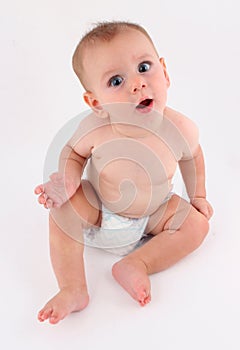 Curious silly funny baby sitting up