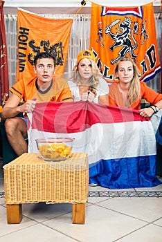 Curious Soccer Fans Watching Match At Home