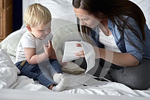 Curious toddler watching pictures of his future sibling