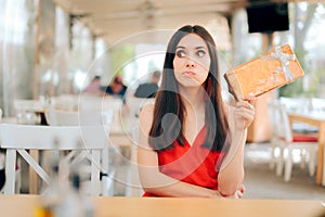 Curious Woman Checking Gift Box on a Date