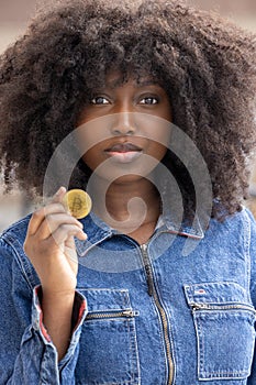 Curious Woman Holding Bitcoin in Denim Outfit