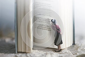 Curious woman reads a giant book photo
