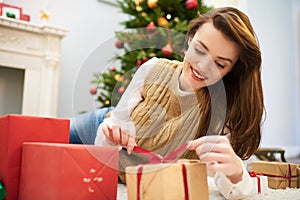 Curious Woman Unwrapping Christmas Gift Box