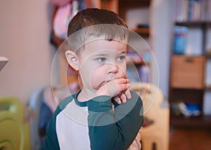 curious young boy watching intently while bending his wrist