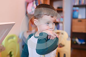 curious young boy watching intently while bending his wrist
