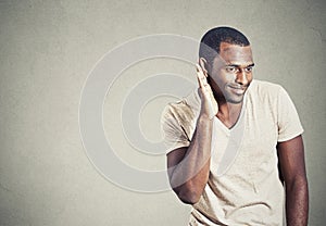 Curious young man eavesdropping listening in on conversation photo