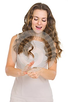 Curious young woman checking coin tossing result