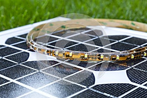Curled LED strip on photovoltaic solar panel