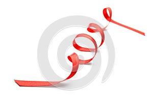 Curled red ribbon on white background