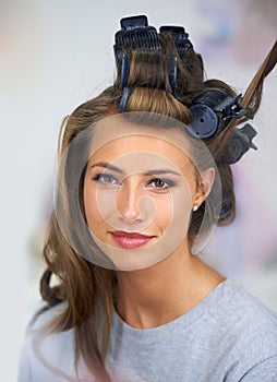 Curled to perfection. A beautiful young woman spending the day getting her hair and makeup done.